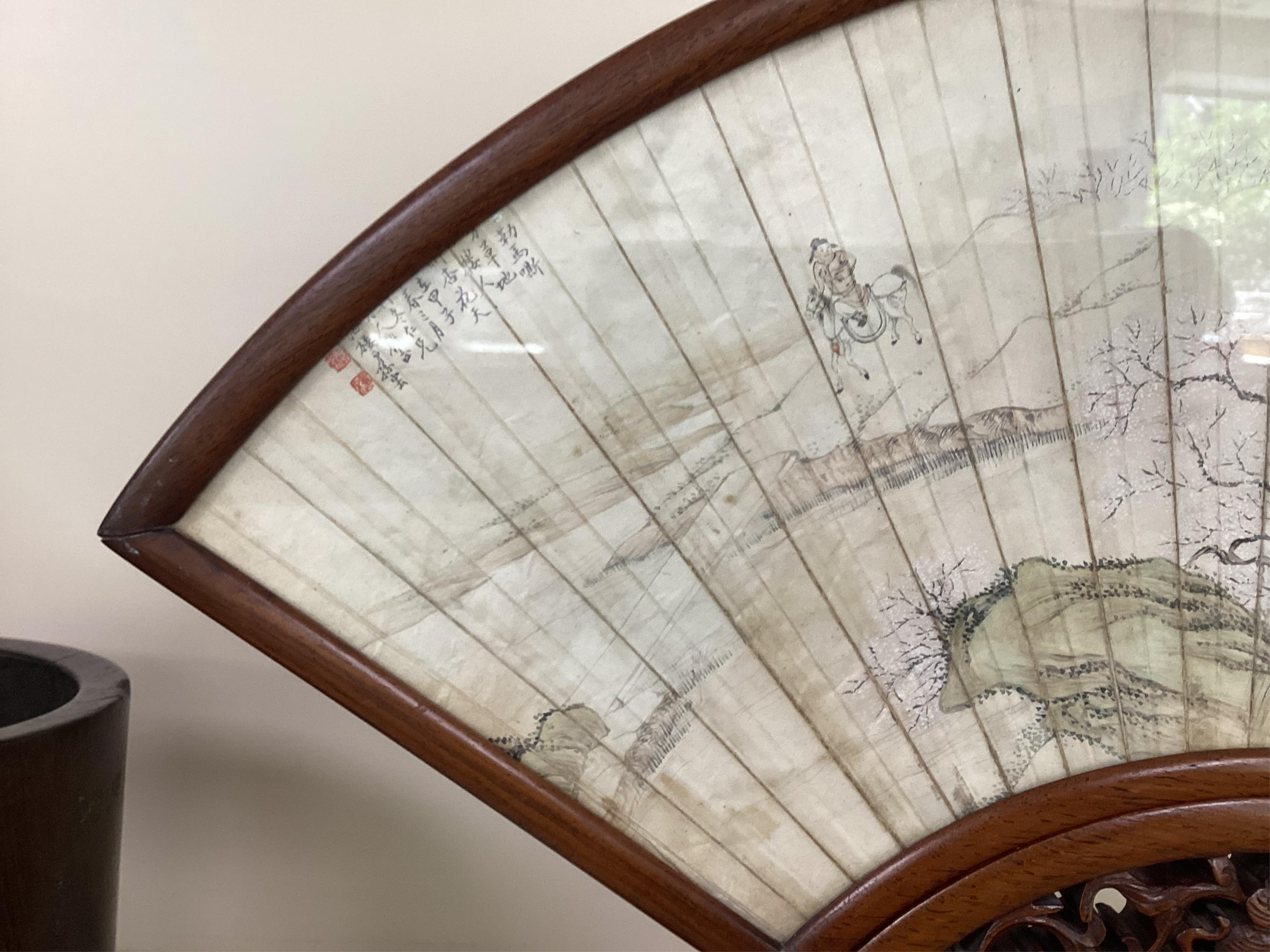 A Chinese painted leaf fan and hardwood stand, late 19th century